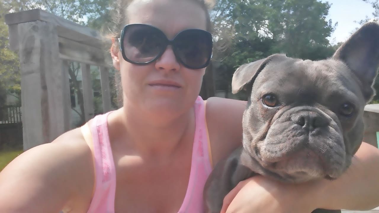 A Happy Pet caregiver on an outdoor walk with a client's dog in Lindenhurst, IL